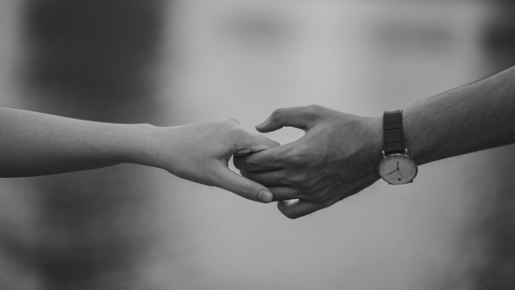 Teachly hands holding Monochrome image of two hands holding, symbolizing love and connection.